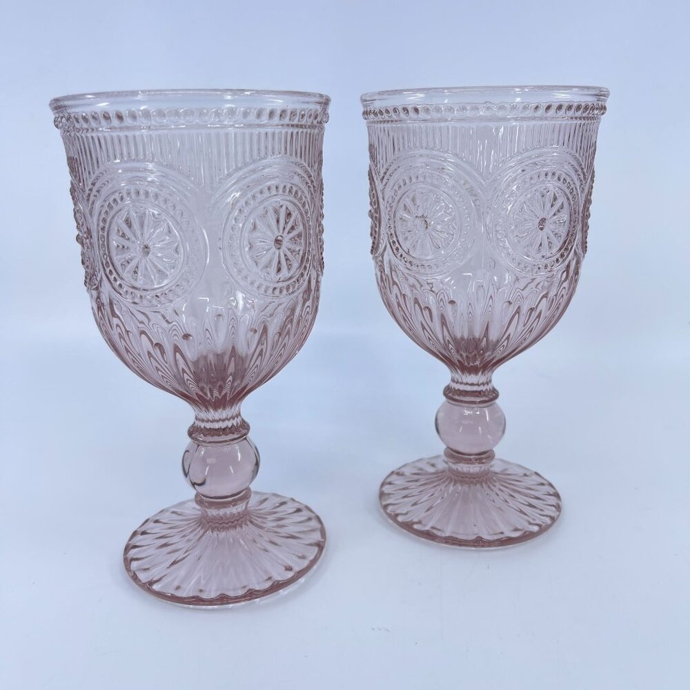 pink pressed glass goblet with intricate starburst pattern and fluted base pair